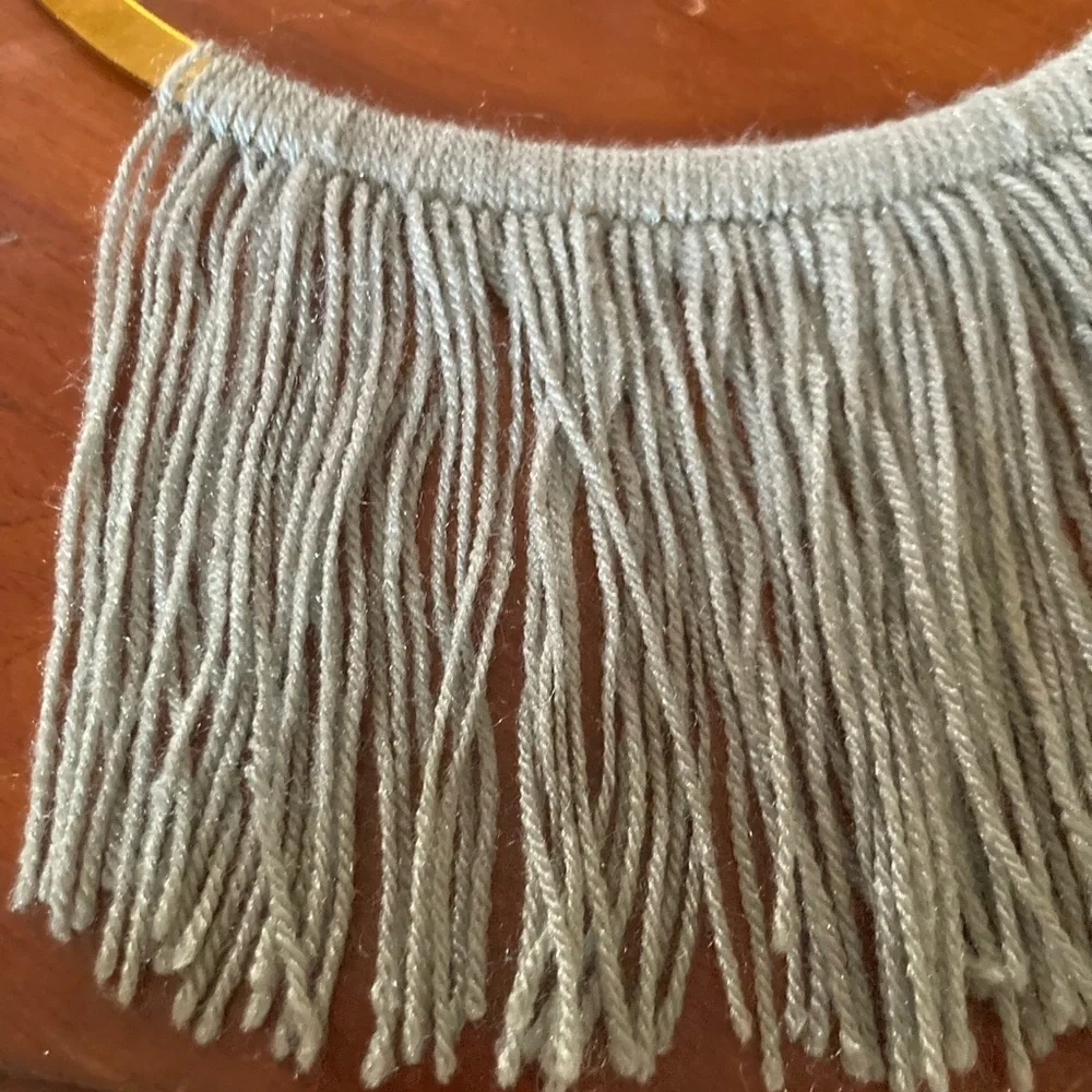 4/$25 Boho Gold finish semi circle metal ring & grey yarn fringe. In EUC.